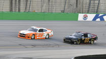 Austin Cindric (22) tries to fight off the challenge from Morgan Shepherd (89) during the NASCAR Xfinity Series auto race at Kentucky Speedway in Sparta, Ky., Friday, July 12, 2019. (AP Photo/Timothy D. Easley)