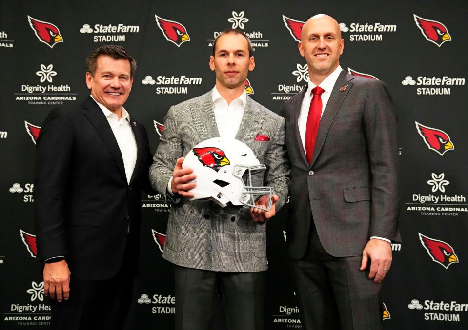 Jonathan Gannon is introduced as the new head coach of the Arizona Cardinals by team president Michael Bidwill and general manager Monti Ossenfort (right) during a news conference at the Cardinals training facility in Tempe on Feb. 16, 2023.