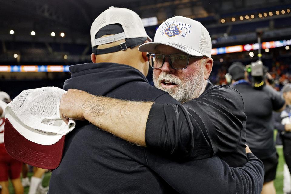 New Mexico State coach Jerry Kill hugs an assistant coach after New Mexico State's 24-19 win over Bowling Green in the Quick Lane Bowl on Monday, Dec. 26, 2022, at Ford Field.
