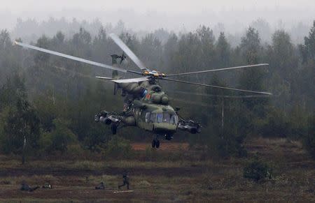 A Mi-8 helicopter flies above servicemen during the Zapad 2017 war games at a range near the town of Borisov, Belarus September 20, 2017. REUTERS/Vasily Fedosenko