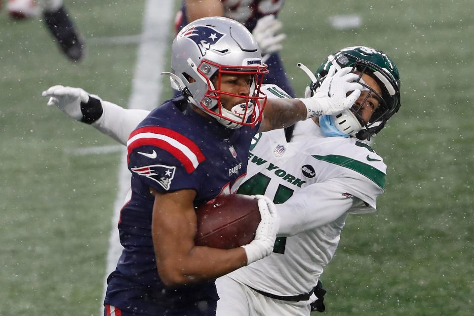 Patriots wide receiver Jakobi Meyers stiff-arms New York Jets safety Matthias Farley after a catch on Jan. 3 at Gillette Stadium.