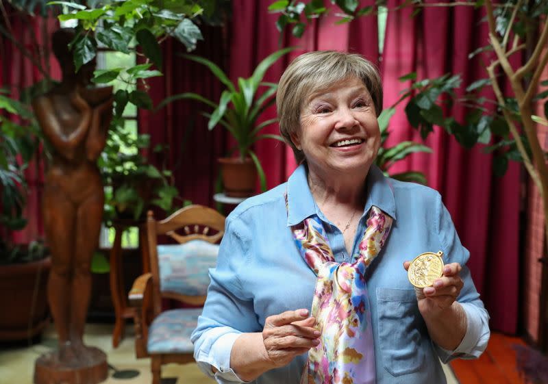 Legendary Soviet gymnast Larisa Latynina shows her Olympic gold medal got in the Olympic Games in Tokyo in 1964, in her home in village Kalyanino