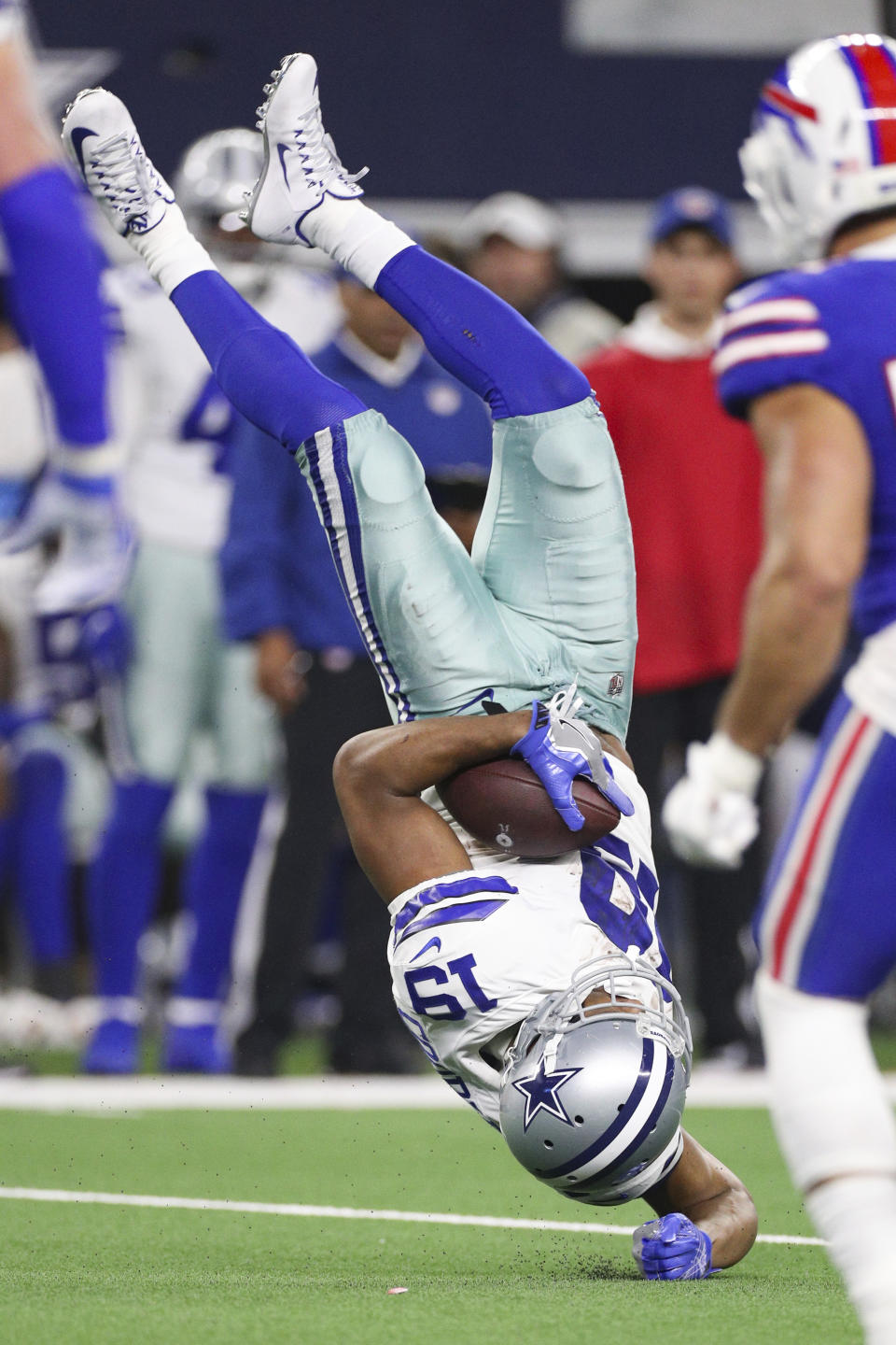 Dallas Cowboys wide receiver Amari Cooper (19) is upended after catching the ball during an NFL game against the Buffalo Bills, Thursday, Nov. 28, 2019 in Dallas. The Bills defeated the Cowboys 26-15. (Margaret Bowles via AP)