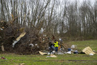 Volunteers comb through an area that was heavily damage by a tornado in Sullivan, Ind., Saturday, April 1, 2023, as search-and-rescue efforts continue. Storms that spawned possibly dozens of tornadoes have killed several people in the South and Midwest. (AP Photo/Doug McSchooler)