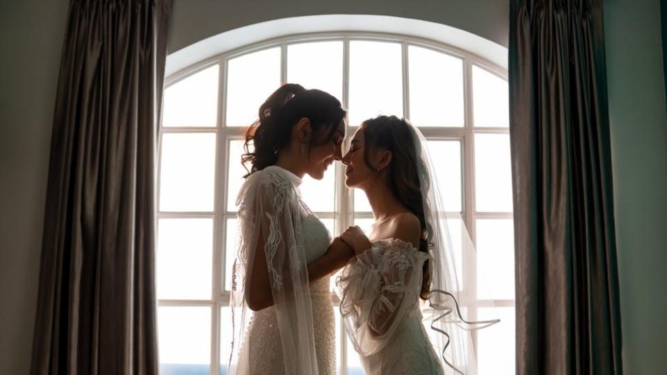 two brides having private moment on wedding day