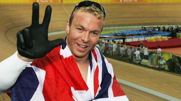 Sir Chris Hoy holds up three fingers in celebration of his triple gold.