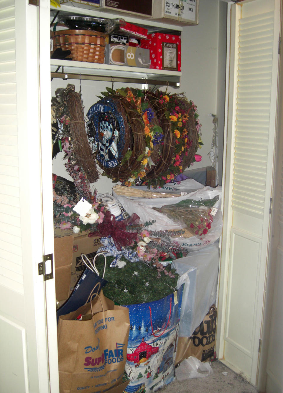 In this undated image released by Seriously Organized, a cluttered closet of Christmas decorations is shown prior to an organizing project. Nikki Havens of Seriously Organized in Bloomington, Minn., recommends starting with your entry hall closet. Small closet or walk-in, it’s important to use the most convenient spot in your home to your advantage. (AP Photo/Seriously Organized)