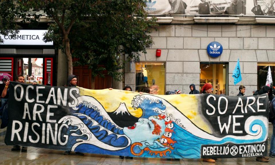 People attend an Extinction Rebellion protest against climate change in Madrid