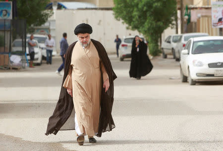 Iraqi Shi'ite cleric Moqtada al-Sadr attends to cast his vote at a polling station during the parliamentary election in Najaf, Iraq May 12, 2018. REUTERS/Alaa al-Marjani