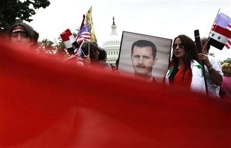 Syrian Americans rally in support of the regime of Syrian President Bashar al-Assad and against proposed U.S. military action against Syria, in a park at the U.S. Capitol in Washington, September 9, 2013. REUTERS/Jonathan Ernst