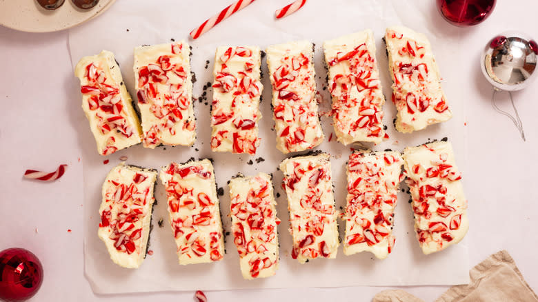 cut cheesecake bars on parchment paper