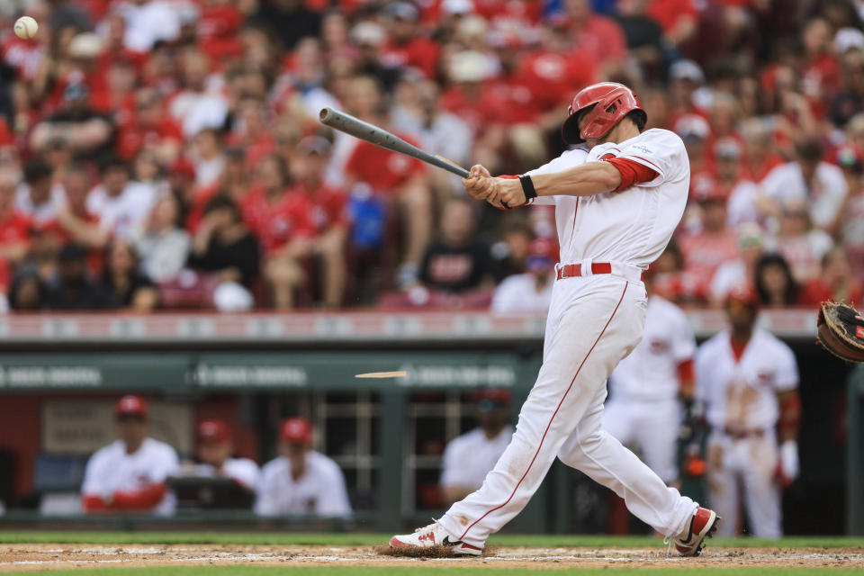 Cincinnati Reds' Wil Myers breaks his bat as he hits an RBI-double during the fifth inning of a baseball game against the Philadelphia Phillies in Cincinnati, Saturday, April 15, 2023. (AP Photo/Aaron Doster)