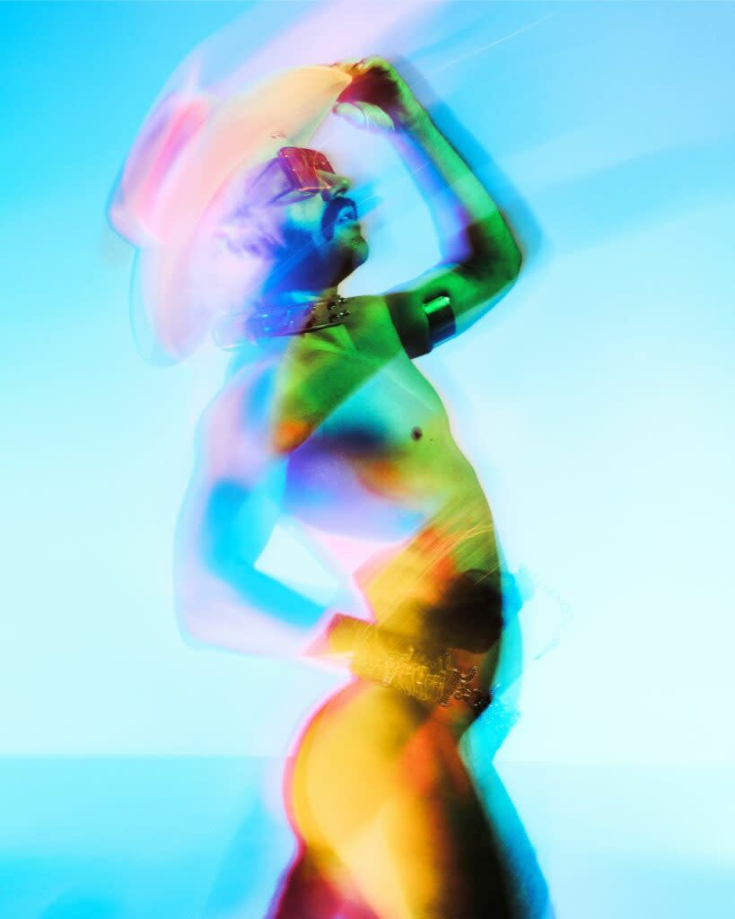 Stylised image of a drag artist against a gradient backdrop