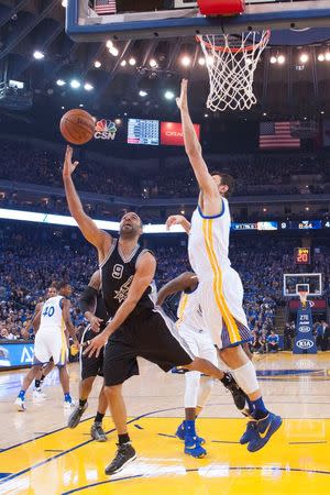 January 25, 2016; Oakland, CA, USA; San Antonio Spurs guard Tony Parker (9) shoots the basketball against Golden State Warriors center Andrew Bogut (12) during the first quarter at Oracle Arena. Mandatory Credit: Kyle Terada-USA TODAY Sports