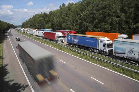 Lorries are parked on the M20 motorway, which leads from London to the Channel Tunnel terminal at Ashford and the Ferry Terminal at Dover, as part of Operation Stack in southern England, Britain July 31, 2015. REUTERS/Neil Hall