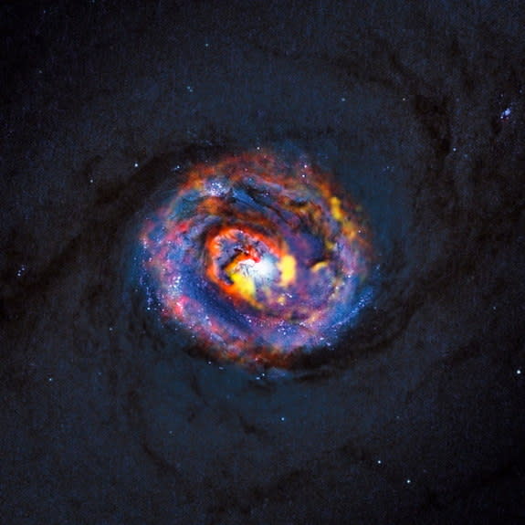 This detailed view shows the central parts of the nearby active galaxy NGC 1433. The dim blue background image, showing the central dust lanes of this galaxy, comes from the NASA/ESA Hubble Space Telescope. Image released Oct. 16, 2013.