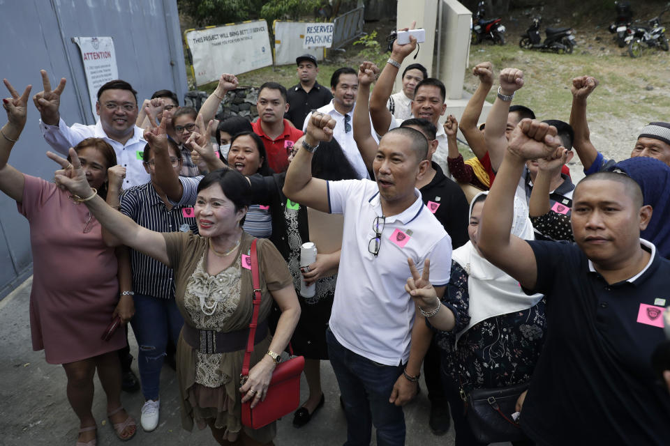 House representative Esmael Mangudadatu, center, whose wife and relatives were victims in a 2009 election-related killings, gestures with family and supporters as he steps out the court inside a prison jail at Camp Bagong Diwa, suburban Taguig, Philippines, Thursday, Dec. 19, 2019. The Philippine court on Thursday found key members of a powerful political clan guilty of a 2009 massacre in a southern province that left 57 people, including 32 media workers, dead in a brazen act that horrified the world. (AP Photo/Aaron Favila)