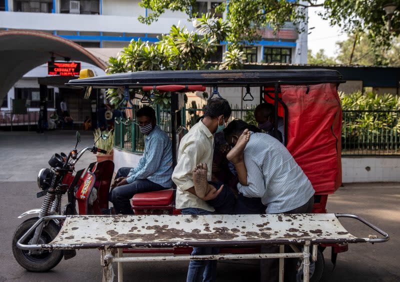 Shayam Narayan is brought to the coronavirus disease (COVID-19) casualty ward by his family members in a rickshaw, at Guru Teg Bahadur hospital, amidst the spread of the disease in New Delhi