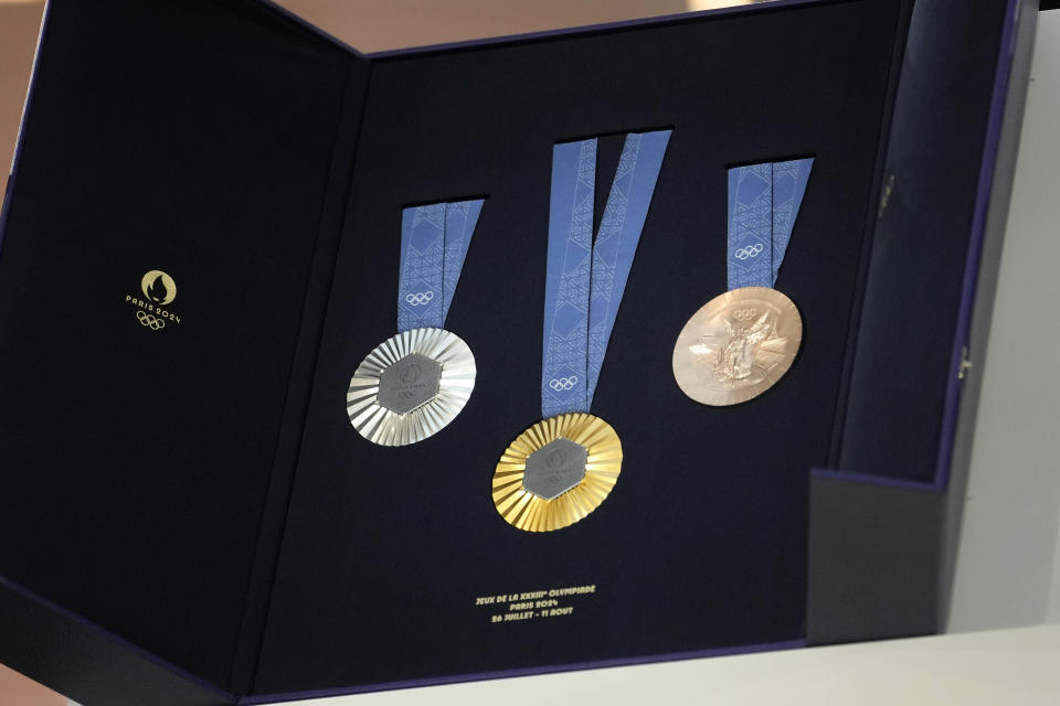 The medals for the Paris 2024 Olympic are displayed at the Paris Olympic organizers in Saint-Denis, outside Paris, Thursday, Feb. 8, 2024. A hexagonal, polished piece of iron taken from the iconic landmark is being embedded in each gold, silver and bronze medal that will be hung around athletes' necks at the July 26-Aug. 11 Paris Games and Paralympics that follow. (AP Photo/Thibault Camus)