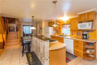 <p>The kitchen features an island, perfect for family meals. </p>