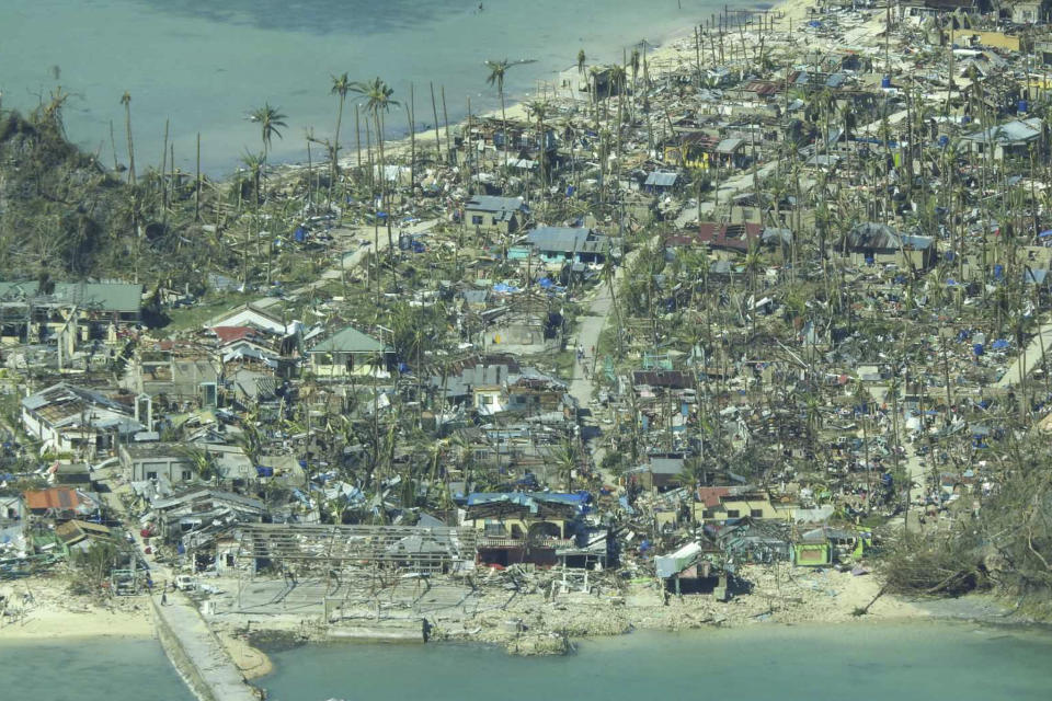 This photo provided by the Philippine Coast Guard, shows damaged houses caused by Typhoon Rai at a coastal village in Surigao del Norte province, southern Philippines on Friday, Dec. 17, 2021. A strong typhoon engulfed villages in floods that trapped residents on roofs, toppled trees and knocked out power in southern and central island provinces, where more than 300,000 villagers had fled to safety before the onslaught, officials said. (Philippine Coast Guard via AP)