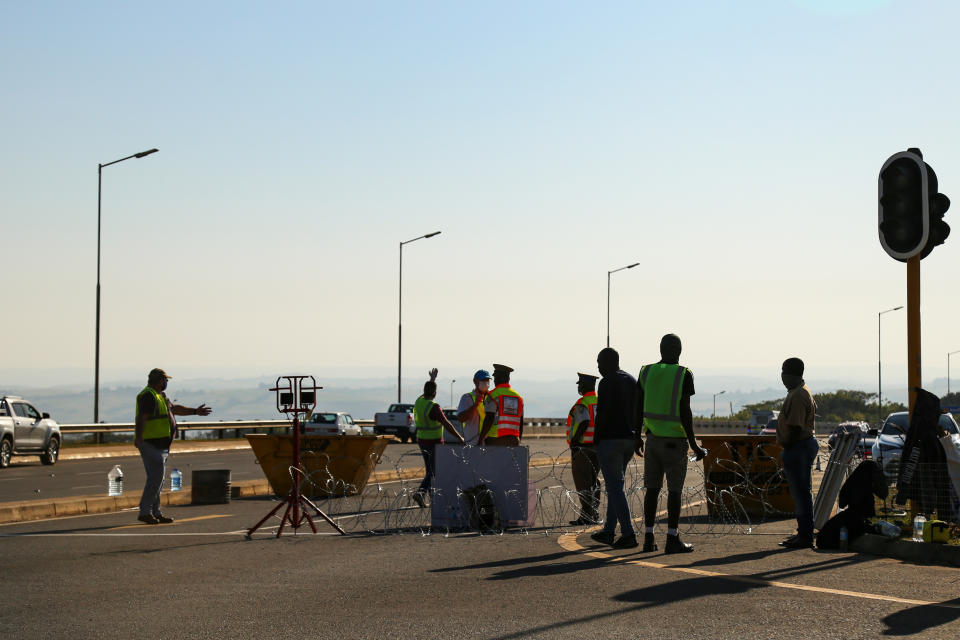 Image: Volunteers man a traffic checkpoint at a highway interchange into a suburb of Durban, South Africa, to prevent unrest after a week of riots. (Linda Givetash / for NBC News)