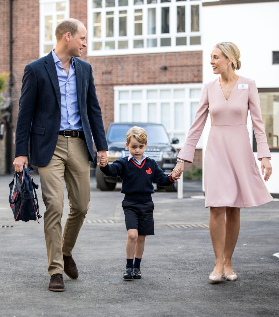 Prince George with his father and Thomas’s Battersea lower school head Helen Haslem (Richard Pohle/The Times/PA) (PA Archive)