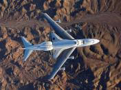 FILE PHOTO: The space shuttle Endeavour, mounted atop its modified Boeing 747 carrier aircraft, flies over California's Mojave Desert on its way back to the Kennedy Space Center