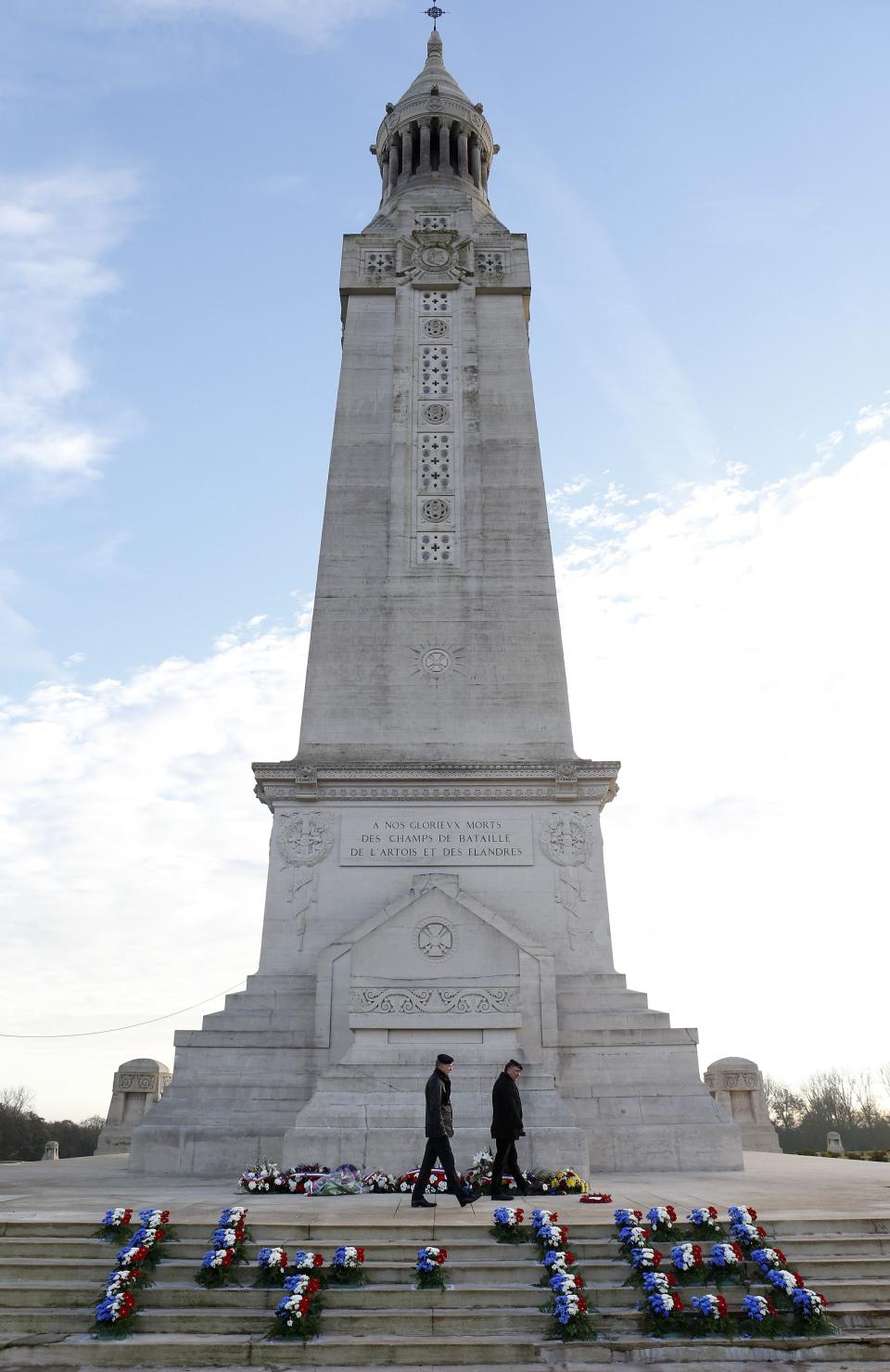 Honour guards patrol around the memorial during Armistice day at the French national war cemetery at Notre Dame de Lorette in Ablain Saint Nazaire