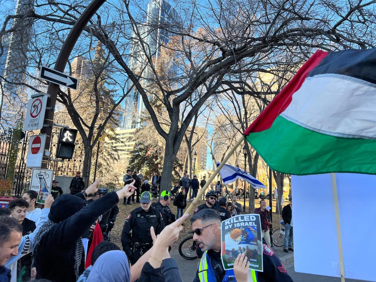 Police officers interact with protesters at an event called 'Justice for Palestinians' on Oct. 15 in Olympic Plaza in downtown Calgary. A similar event held this Sunday resulted several arrests. (Helen Pike/CBC - image credit)