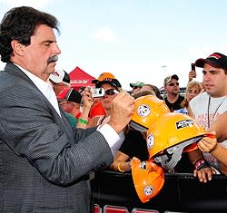 Mike Helton signs autographs for fans at the track