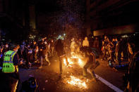 Demonstrators burn garbage in Oakland, Calif., on Friday, May 29, 2020, while protesting the Monday death of George Floyd, a handcuffed black man in police custody in Minneapolis. (AP Photo/Noah Berger)