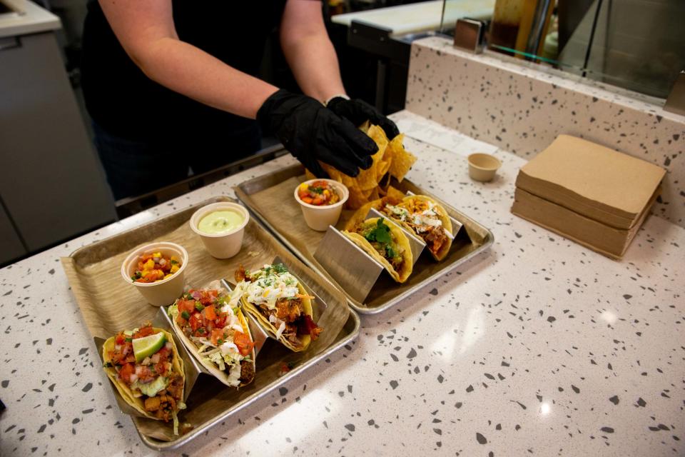 Chips are put on trays of tacos at Streats Taco Kitchen. The restaurant in downtown Zeeland is now looking to acquire a liquor license.
