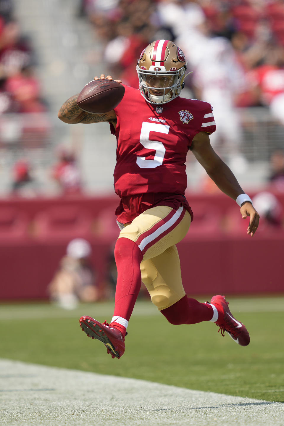 San Francisco 49ers quarterback Trey Lance (5) runs out of bounds during the first half of an NFL preseason football game against the Las Vegas Raiders in Santa Clara, Calif., Sunday, Aug. 29, 2021. (AP Photo/Tony Avelar)