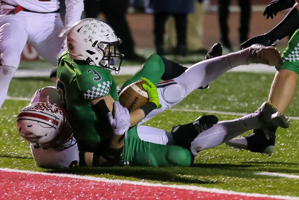 Badin's Austin Buckle (3) appears to be stopped just shy of the goal line, but the play was ruled a touchdown for a go-ahead 17-10 score in the second half during a Division III regional final at Trotwood High School on Nov. 18, 2022.