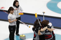 Curling - Pyeongchang 2018 Winter Olympics - Women's Semi-final - South Korea v Japan - Gangneung Curling Center - Gangneung, South Korea - February 23, 2018 - South Korea players celebrate after winning as vice-skip Chinami Yoshida of Japan and skip Satsuki Fujisawa of Japan look on. REUTERS/Cathal McNaughton