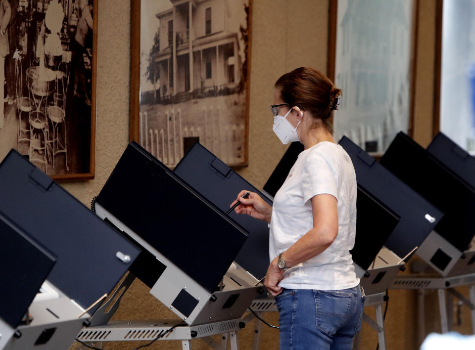 Amid concerns of the spread of COVID-19, a voter looks over their selection at a polling station, Tuesday, July 14, 2020, in Richardson, Texas. (LM Otero/AP)