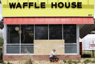 <p>A worker vacuums up shattered glass outside a Waffle House restaurant Monday, April 23, 2018, in Nashville, Tenn. (Photo: Mark Humphrey/AP) </p>