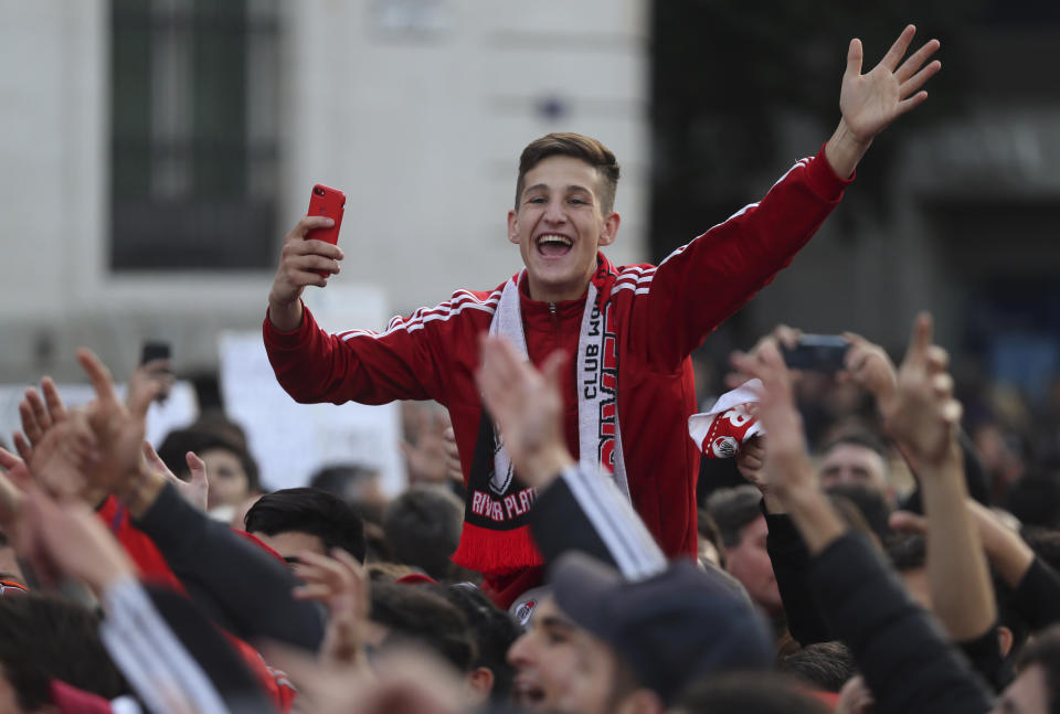 River Plate supporters cheer during a gathering at the Puerta del Sol square in Madrid Saturday, Dec. 8, 2018. The Copa Libertadores Final between River Plate and Boca Juniors will be played on Dec. 9 in Madrid, Spain, at Real Madrid's stadium. (AP Photo/Armando Franca)