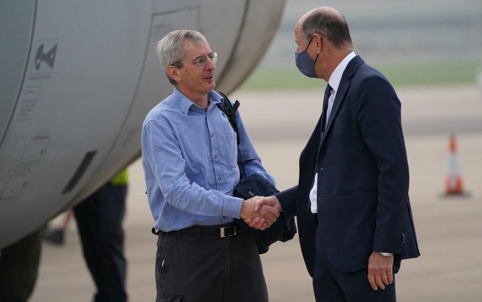 Ambassador to Afghanistan Sir Laurie Bristow (left) is greeted by Sir Philip Barton, Permanent Under-Secretary of the Foreign, Commonwealth and Development Office, as he exits a plane after being evacuated from Kabul, upon its arrival at RAF Brize Norton base in Oxfordshire - Jonathan Brady 