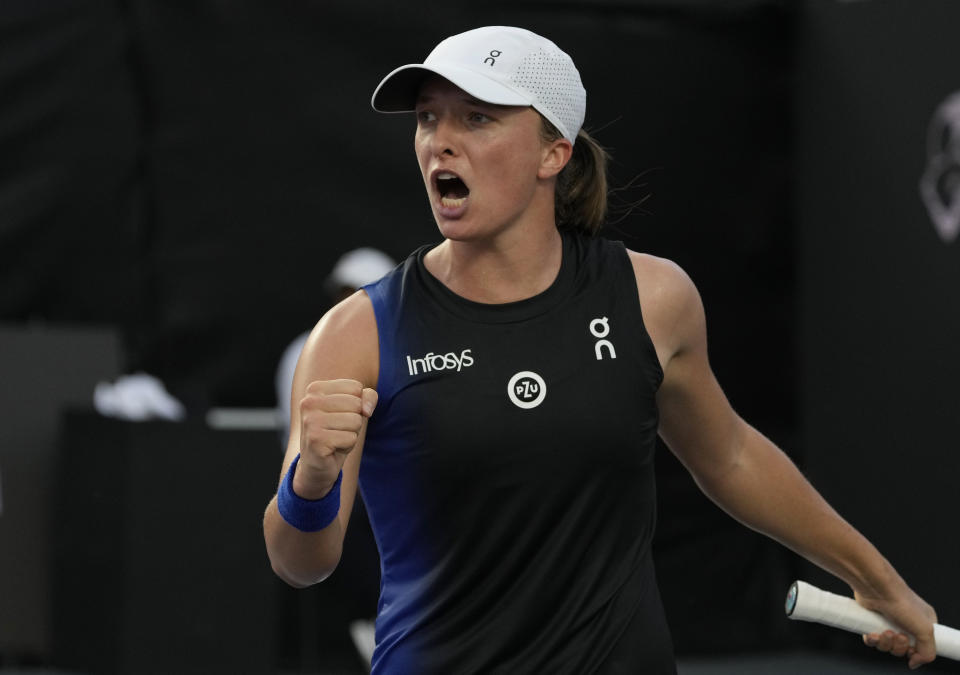 Iga Swiatek, of Poland, celebrates winning a point during a women's singles final of the WTA Finals tennis championships against Jessica Pegula, of the United States, in Cancun, Mexico, Monday, Nov. 6, 2023. (AP Photo/Fernando Llano)