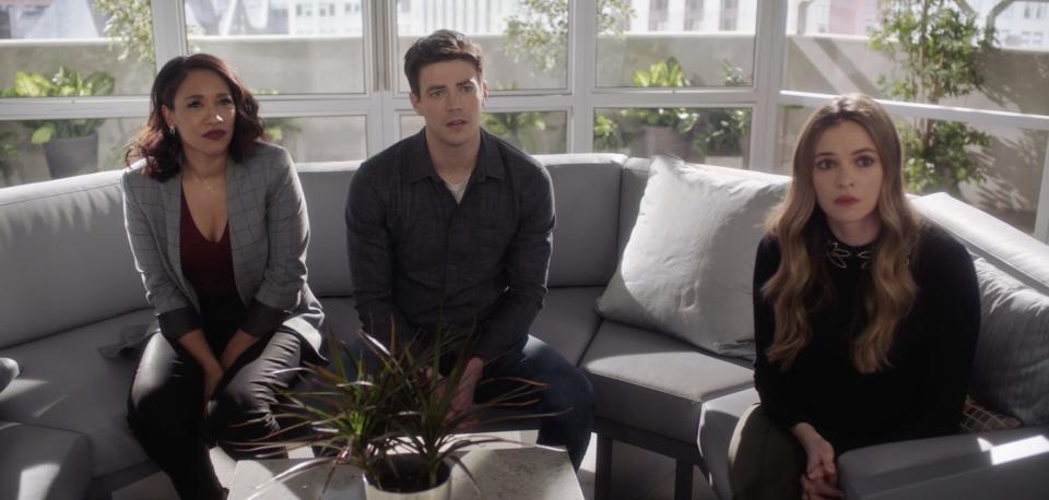 Candice Patton, Grant Gustin, and Danielle Panabaker sitting on a couch on season seven of "The Flash."