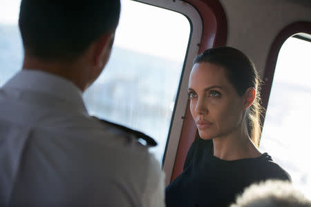 U.S. actress and UNHCR Special Envoy Angelina Jolie (R) talks with an Armed Forces of Malta officer on the bridge of an offshore patrol boat at the Maritime Squadron base in Valletta's Marsamxett Harbour, in this handout taken September 14, 2014 and released September 15, 2014 courtesy of the Armed Forces Malta Press Office. REUTERS/Justin Gatt/Armed Forces of Malta Press Office/Handout via Reuters