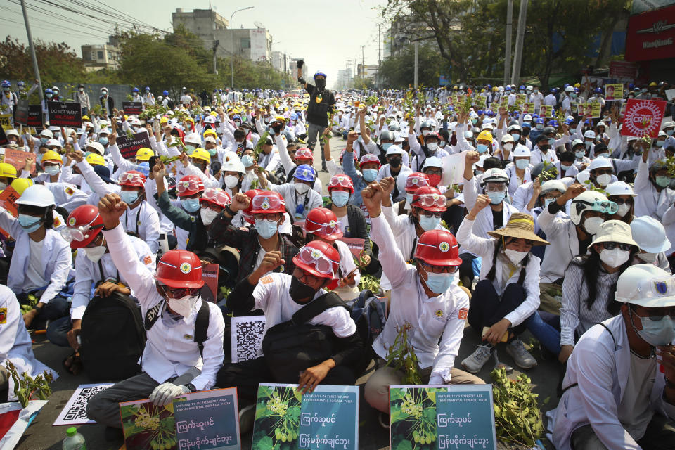 Protesters shout slogans during a protest against the military coup in Mandalay, Myanmar, Sunday, Feb. 28, 2021. Police fired tear gas and water cannons and there were reports of gunfire Sunday in Myanmar's largest city Yangon where another anti-coup protest was underway with scores of students and other demonstrators hauled away in police trucks. (AP Photo)