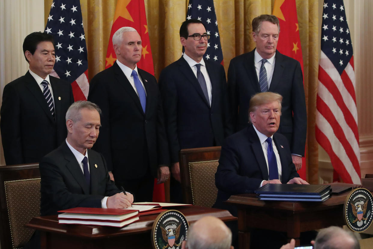 WASHINGTON, DC - JANUARY 15: U.S. President Donald Trump and Chinese Vice Premier Liu He sign phase 1 of a trade deal between the U.S. and China, in the East Room at the White House, on January 15, 2020 in Washington, DC. Phase 1 is expected to cut tariffs and promote Chinese purchases of U.S. farm, and manufactured goods while addressing disputes over intellectual property. Also pictured in rear are Vice President Mike Pence (2nd L), Treasury Secretary Steve Mnuchin (2nd R) and US Trade Representative Robert Lighthizer (R). (Photo by Mark Wilson/Getty Images)