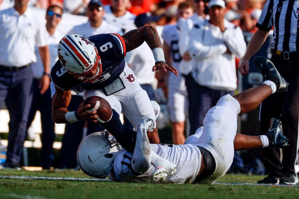 Auburn quarterback Robby Ashford (9) is sacked by Penn State linebacker Abdul Carter (11) during the second half of an NCAA college football game, Saturday, Sept. 17, 2022, in Auburn, Ala. (AP Photo/Butch Dill)