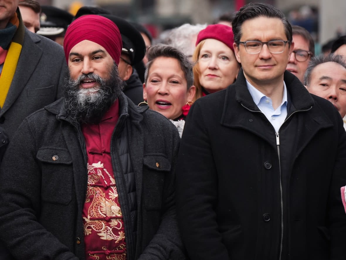 NDP Leader Jagmeet Singh, left, and Conservative Leader Pierre Poilievre stand together before marching in the Lunar New Year parade in Chinatown in Vancouver on Sunday, January 22, 2023. (Darryl Dyck/The Canadian Press - image credit)