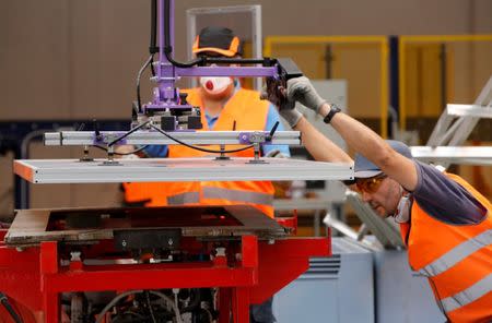 Employees work at Veolia’s solar panel recycling plant in Rousset, France, June 25, 2018. At the plant, photovoltaic panels are dissembled and their constituent parts such as glass, aluminium, silicon and plastics are recycled. REUTERS/Jean-Paul Pelissier