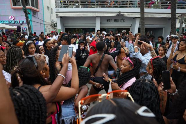 Keandre Reese, center, dances in a crowd of spring breakers front of Wet Willies on Sunday, March 19, 2023, on Ocean Drive in Miami Beach.