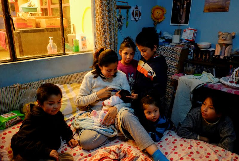 Irma Arancibia, who gave birth at home amidst the coronavirus disease (COVID-19) outbreak, breastfeeds her newborn boy, as her other children look on, in La Paz